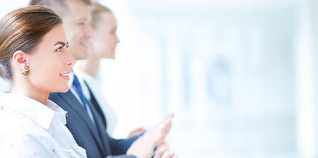 Smiling business people applauding a good presentation in the officeの写真素材