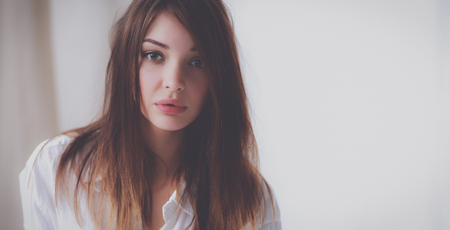 Portrait of beautiful woman on bed at bedroomの写真素材