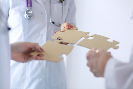Doctors and nurses in a medical team stacking handsの写真素材