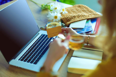 Young woman holding credit card and using laptop computer. Online shopping concept.の写真素材