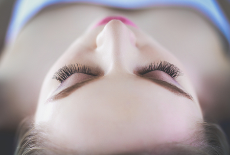 Young woman lying on a massage table,relaxing with eyes closed. Woman. Spa salonの写真素材