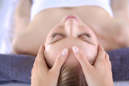 Young woman lying on a massage table,relaxing with eyes closed. Woman. Spa salonの写真素材