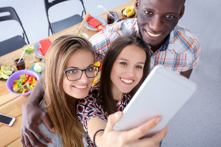 Group of people doing selfie during lunch. Self. Friends. Friends are photographed for eatingの写真素材