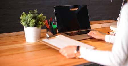 Young female working sitting at a deskの写真素材