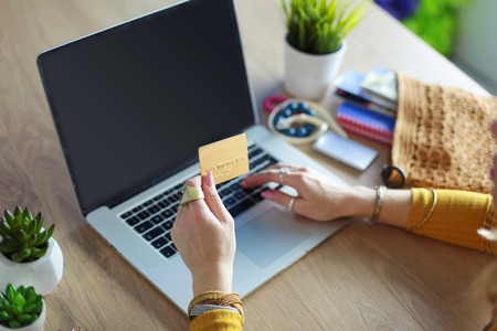 Young woman on a coffee break or enjoying the coffee-break, Using laptop computer.の写真素材