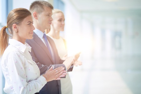 Smiling business people applauding a good presentation in the office . Smiling business peopleの写真素材