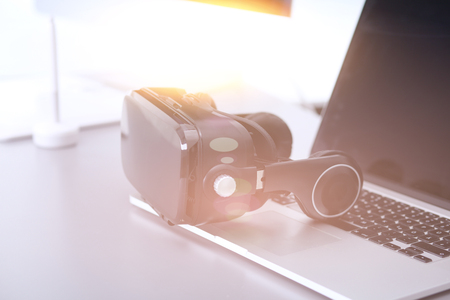 Virtual reality goggles on desk with laptop. business. 3d technologyの写真素材