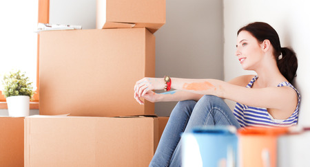 Woman in a new home with cardboard boxes. Woman in the house.の写真素材