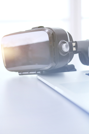 Virtual reality goggles on desk with laptop. business. 3d technologyの写真素材