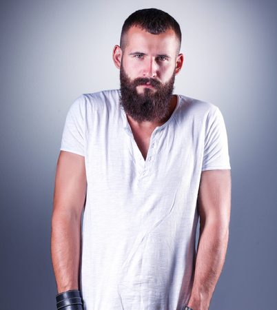 Portrait of handsome man standing, isolated on grey backgroundの写真素材
