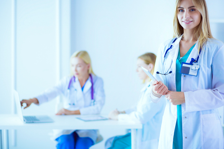 portrait of a young female doctor, with aipads in hand, in a medical officeの写真素材