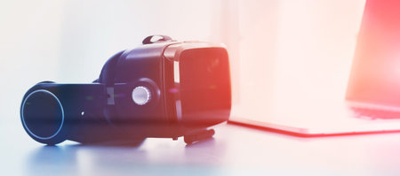 Virtual reality goggles on desk with laptop. business. 3d technology