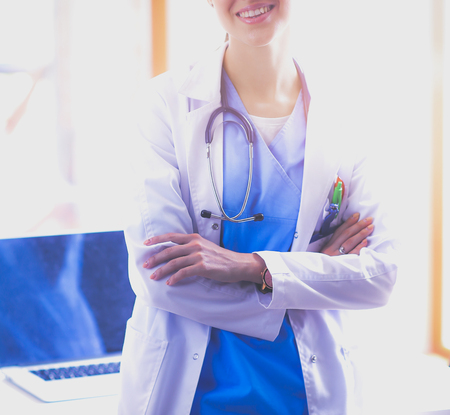 Woman doctor standing near window at hospital. Woman doctorの写真素材