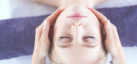 Young woman lying on a massage table,relaxing with eyes closed. Woman. Spa salonの写真素材