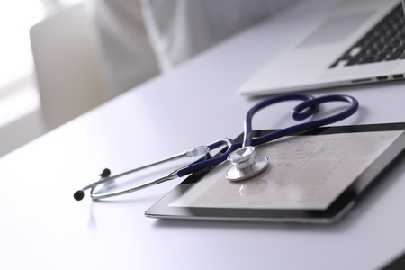 Medical equipment: blue stethoscope and tablet on white background. Medical equipmentの写真素材