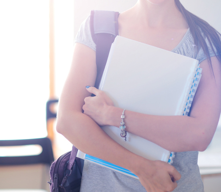 Portrait of young student woman holding exercise books. Student womanの写真素材