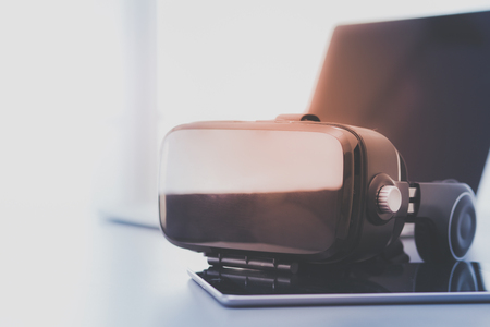 Virtual reality goggles on desk with laptop. business. 3d technologyの写真素材
