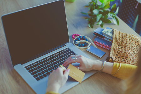 Young woman on a coffee break or enjoying the coffee-break, Using laptop computer.の写真素材