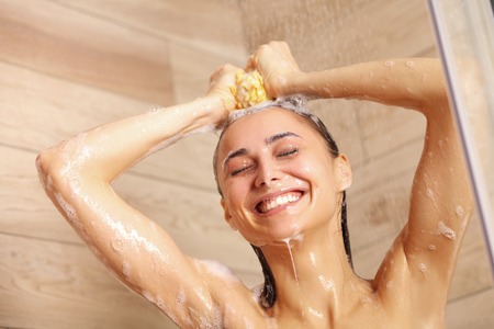 Child little girl sleeps in the bed with a toy teddy bear.の写真素材