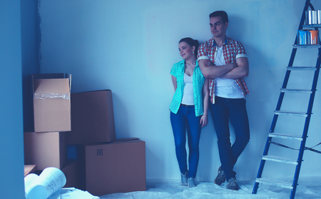 Portrait of young couple moving in new homeの写真素材