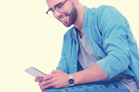 Young man sitting on chair and using mobile phone. Startupper. Young entrepreneur.の写真素材