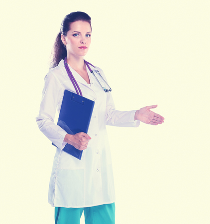 Smiling female doctor with a folder in uniform standing at hospital. Smiling female doctorの写真素材