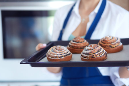 Woman cook holding plate with homemade baked goods