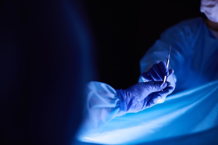 Cropped picture of scalpel taken doctors performing surgery.の写真素材