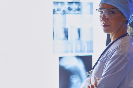 Image of attractive woman doctor looking at x-ray results.の写真素材