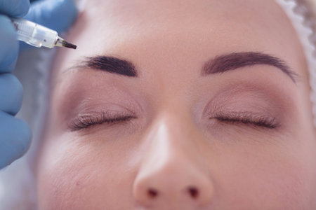 Closeup of beautiful woman with thick brows in beauty salon.