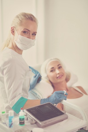 Closeup of beautiful woman with thick brows in beauty salon.の写真素材