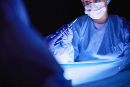 Cropped picture of scalpel taken doctors performing surgery.の写真素材
