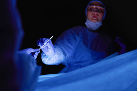 Cropped picture of scalpel taken doctors performing surgery.