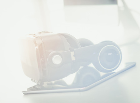 Virtual reality goggles on desk with laptop. business. 3d technology.の写真素材