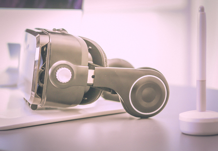 Virtual reality goggles on desk with laptop. business. 3d technologyの写真素材