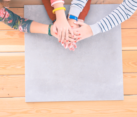 Three women sitting at a desk, together.の写真素材
