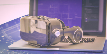 Virtual reality goggles on desk with laptop. business. 3d technologyの写真素材