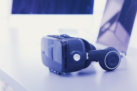 Virtual reality goggles on desk with laptop. business. 3d technologyの写真素材