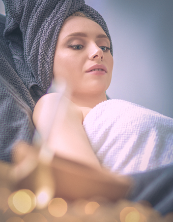 Young woman lying on a massage table,relaxing with eyes closed. Woman. Spa salonの写真素材