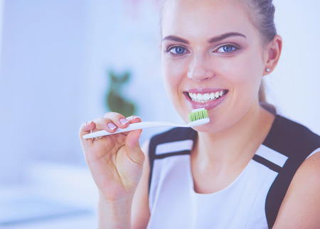 Young pretty girl maintaining oral hygiene with toothbrush.の写真素材