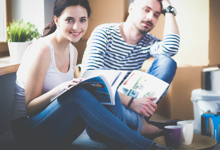 Couple moving in house sitting on the floorの写真素材