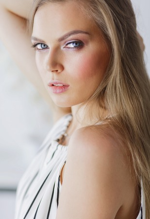 Beautiful woman face close up studio on whiteの写真素材