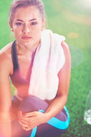 Relax in grass - tired woman after sport. Relax.の写真素材