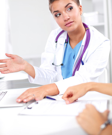 Doctor and patient sitting on the desk at officeの写真素材