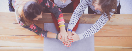 Three women sitting at a desk, together.の写真素材