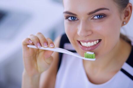 Young pretty girl maintaining oral hygiene with toothbrush.の写真素材