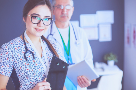 A medical team of doctors, man and woman,standing in officeの写真素材