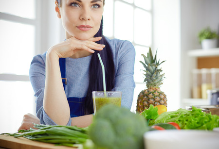 Young with with basket of fresh vegetables in the kitchenの写真素材