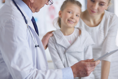 Little girl with her mother at a doctor on consultationの写真素材