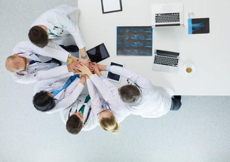 Doctors and nurses in a medical team stacking handsの写真素材